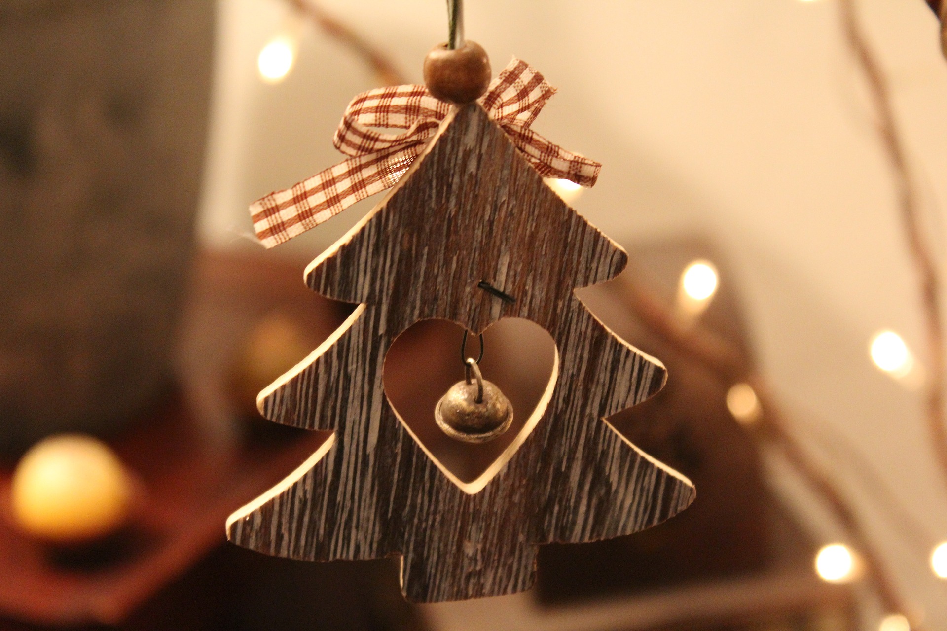 Wooden Christmas tree ornament on a rustic background, used as a decorative banner behind the “Reserve Your Space” section on the Perry Hall Craft Fair Vendor Information page.